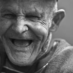 grayscale-photo-of-laughing-old-man-156731